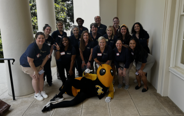 GTAAN Best Practices planning committee pose with Buzz.