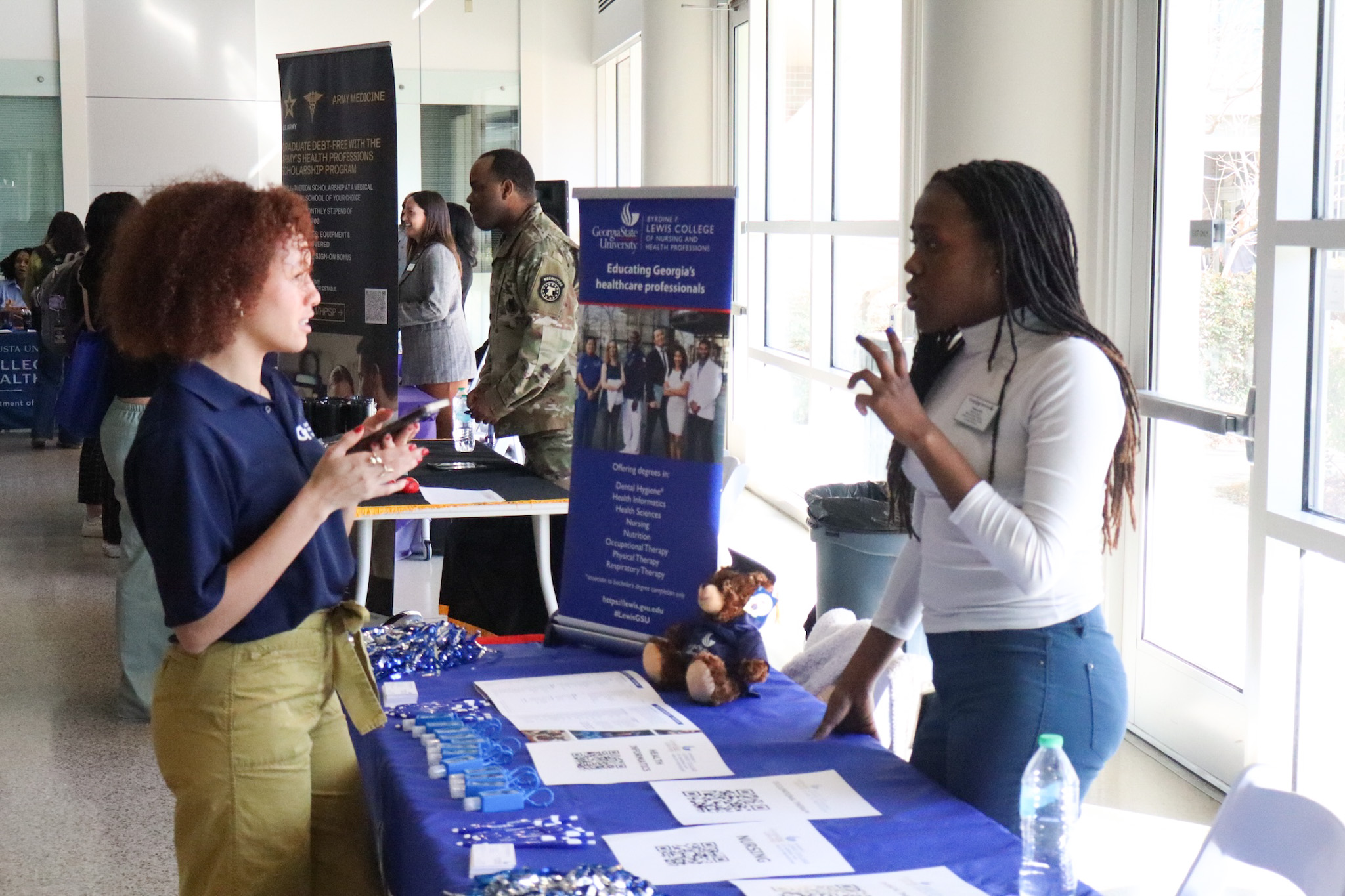 Students speaking with a health professional recruiter. 