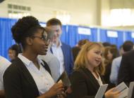 Student stands in line at a career fair
