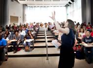 teacher standing in front of class in auditorium