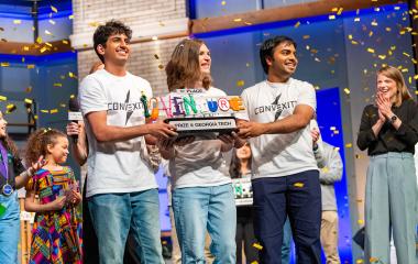 Winning team, Convexity Electronics, holds InVenture Prize first place trophy onstage.
