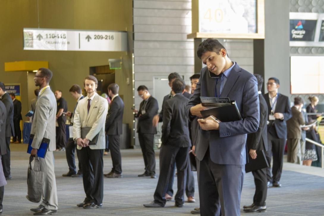 Student on phone in career fair